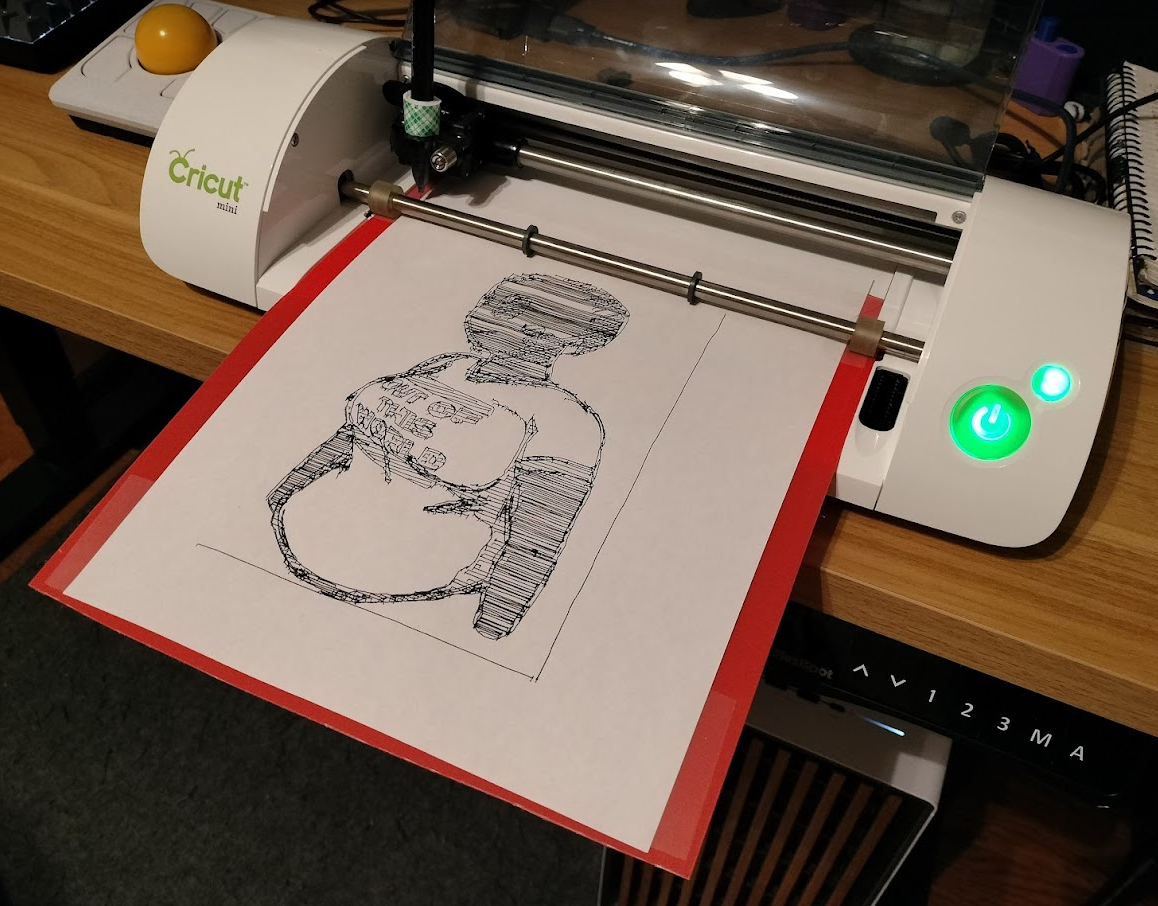 A Cricut Mini vinyl cutter retrofitted into a plotter, with a finished picture of Nova sitting on it